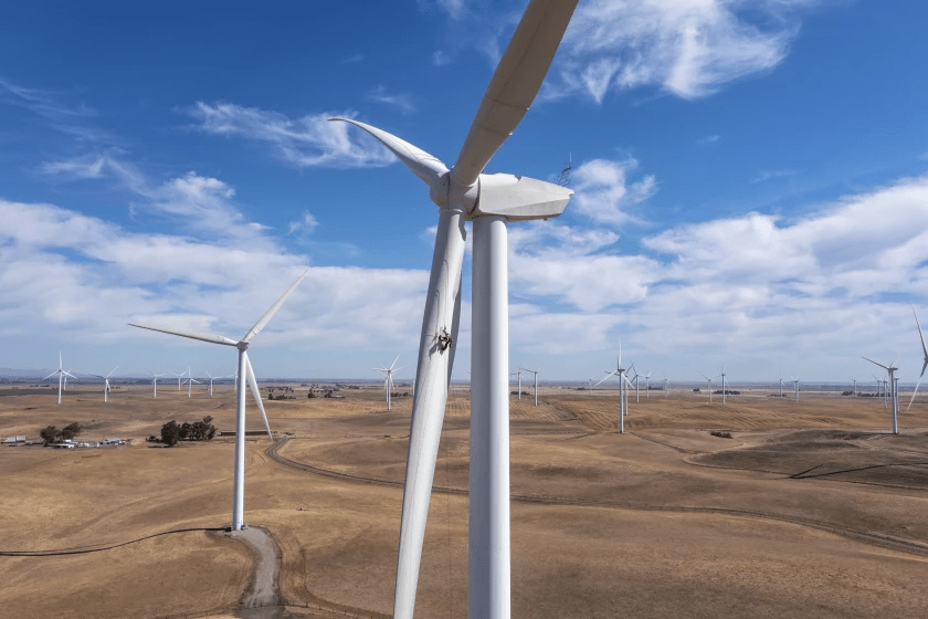 A wind energy technician repairs a 148-foot-long fiberglass turbine blade in California’s Montezuma Hills.(Brian van der Brug / Los Angeles Times)