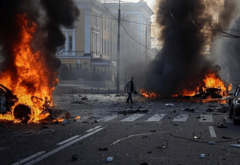 Cars burn after a Russian military strike in central Kyiv, October 10, 2022. REUTERS/Gleb Garanich