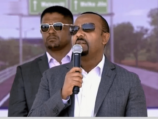 Abiy Ahmed speaks as Shimeles Abdissa (Oromia region president) listens from the back. (Photo : file / Public Domain)